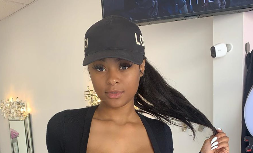 woman wearing black baseball cap over her ponytail hair extension